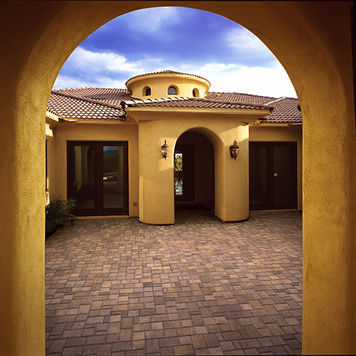  Photo of a patio coutyard made from Territorial blend Town scape pavers. The walls of the Mediterainian Style home a a Tuscan Yellow.  