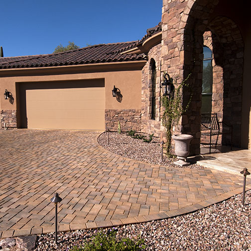 Photo of Townscape Driveway at Southwestern home with a stucco and rough stone facade